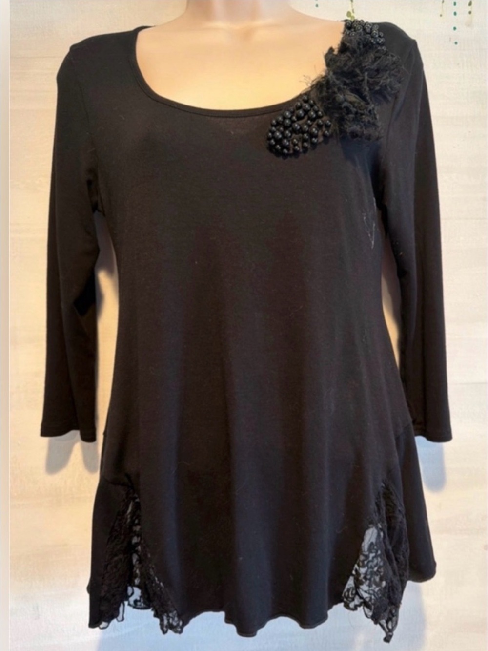 Cute 1/4 length sleeve knit top. With lace embellishments.